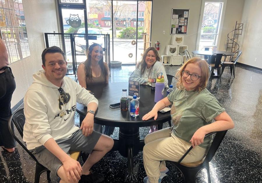 The cafe team and guests at a table